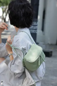Minimalist light green genuine leather mini crossbody bag for women, stylish lunchbox style.