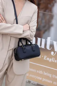Black leather Boston bag for women, stylish small shoulder and crossbody handbag for daily use.