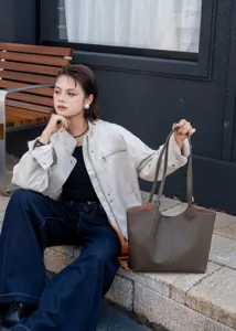 Detailed view of genuine leather tote bag, large capacity commute shoulder bag with double straps.