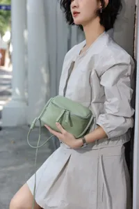 Detail view of a stylish light green genuine leather mini crossbody bag for women daily wear.