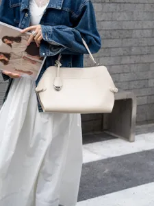 Chic beige leather shoulder bag lifestyle detail showcasing premium texture and hardware.