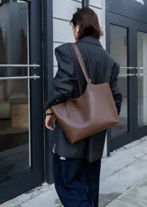 Minimalist brown leather tote bag for women, stylish large capacity single shoulder commute.