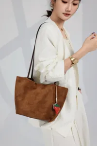 Brown suede tote bag for women, large capacity shoulder bag with cute strawberry charm accessory.