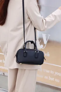 Mini black Boston shoulder bag for women, stylish leather crossbody handbag with top handle.
