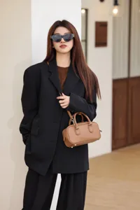 Chic genuine leather Boston bag for women, stylish pillow handbag and shoulder crossbody bag detail.