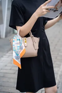 Genuine leather bucket handbag for women, casual tote bag with stylish silk scarf detail.