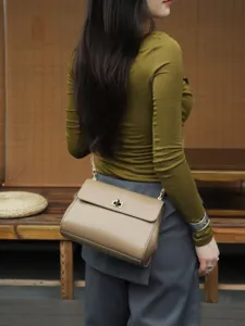 Genuine leather crossbody shoulder bag for women, retro commuter handbag with metal lock.