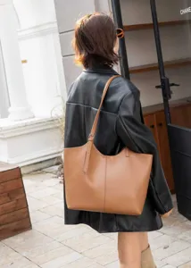 Detail view of the elegant brown leather tote bag showcasing stylish shoulder carry style.