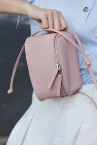 Minimalist pink genuine leather crossbody bag, mini square box design with top handle and zip.
