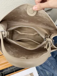 Detailed view of the leather shoulder bag interior, showing large capacity and lining.