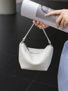 Minimalist white leather mini shoulder bag for women, stylish dumpling handbag with zipper.