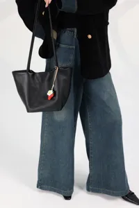Black leather bucket bag for women, large capacity shoulder tote handbag with charm.