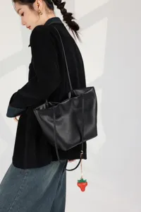 Genuine leather tote bag for women, large capacity shoulder bucket bag with stylish strawberry charm.