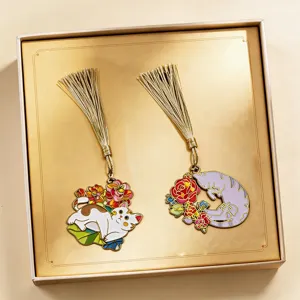 Detailed close-up view of exquisite metal cat bookmarks with golden tassels, creative gift box packaging.