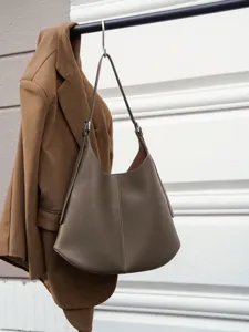Detailed view of genuine leather hobo shoulder bag with smooth texture and delicate stitching.