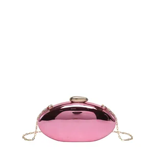 Glossy pink oval evening clutch bag with gold chain strap for women, stylish party handbag.
