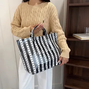 Black and white striped bow patent leather tote bag detail, large capacity shoulder handbag.