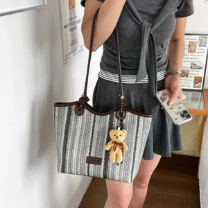 Woven straw tote bag for women, large capacity striped shoulder bag, stylish commuter handbag.