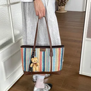 Woven straw tote bag for women, large capacity colorful stripe shoulder bag with cute bear charm.