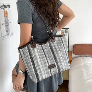Woven straw tote bag for women large capacity striped shoulder bag casual commuter handbag.