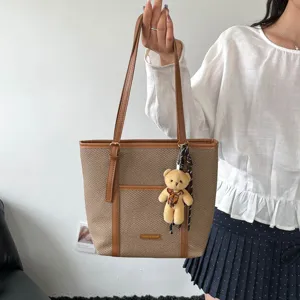 Retro woven canvas tote bag for women large capacity commuter shoulder bag with cute bear charm.