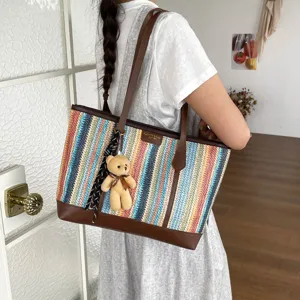 Straw woven tote bag for women, large capacity summer beach handbag with cute bear pendant.