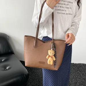 Trendy brown pebbled leather tote bag for women, stylish commuting shoulder handbag.