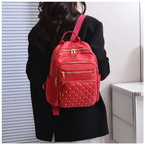 Women red oxford cloth backpack with quilted stud design, casual commute travel school bag.