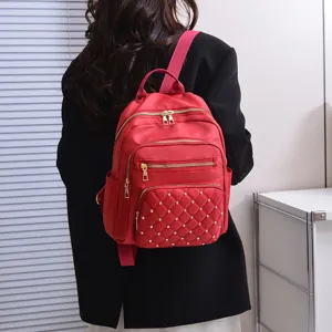 Women red nylon backpack with quilted stud design, lightweight casual daily commuter school bag.