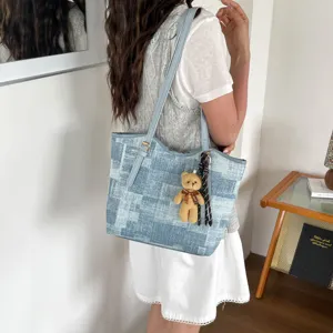 Fashion denim pattern tote bag with cute bear charm, large capacity shoulder bag for daily commute.