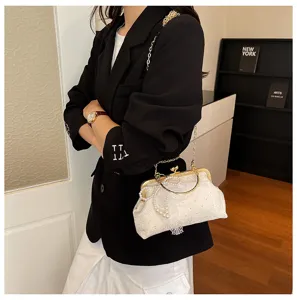 Elegant white lace evening bag with vintage kiss lock, pearl handle and gold chain strap.