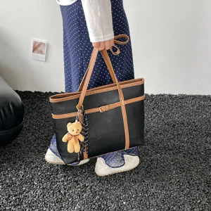 Retro large capacity tote bag, stylish contrast color shoulder bag with cute bear pendant detail.