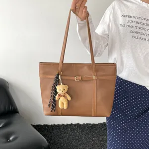 Retro textured large capacity tote bag with stylish belt buckle and cute bear pendant.