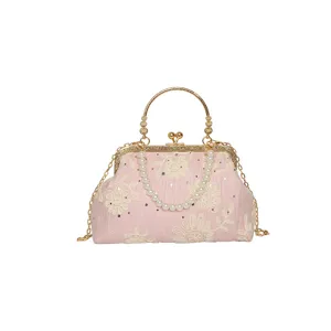 Elegant pink embroidered evening handbag with pearl handle, vintage clasp design and gold chain.