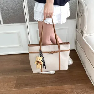 Detailed view of retro large capacity tote bag in beige with brown straps, chic and versatile.