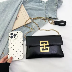 Black PU leather cross-body bag for women with gold chain strap and metal lock clasp trendy style.
