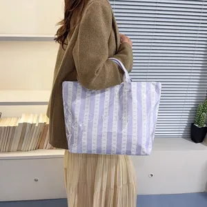 Spacious purple striped canvas tote bag with bow pattern, casual daily shoulder bag for women.