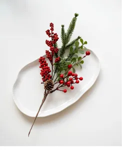 Artificial Christmas red berry pine needle pick for home holiday decor and floral arrangement.