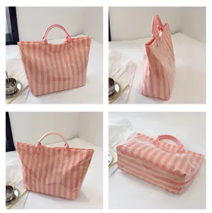 Detailed view of pink striped PVC tote bag, casual large capacity shoulder handbag.