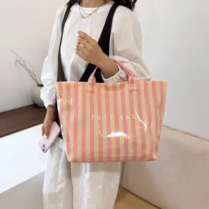 Chic striped PVC tote bag with large capacity, trendy casual style for daily wear.