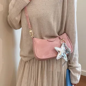 Pink shoulder bag for women with chic silver star charm and elegant crossbody strap.
