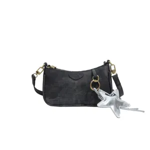 Stylish black shoulder bag with gold hardware and trendy silver star charm for women.