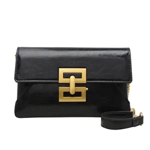 Chic black shoulder crossbody bag with gold metal lock, trendy versatile chain design for women.