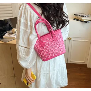 Pink quilted embroidered bucket bag with top handle and shoulder strap for daily stylish look.