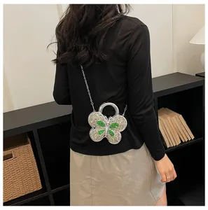 Stylish butterfly-shaped rhinestone crossbody bag detail, chic shoulder chain design.
