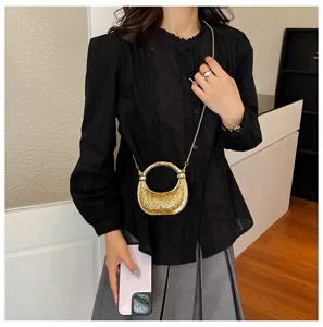 Elegant metallic gold mini evening bag with sparkly glitter and circle handle chic.