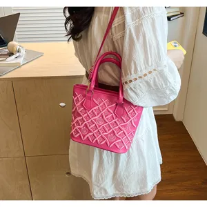 Chic pink shoulder handbag with stylish embroidered lattice design for women daily wear.