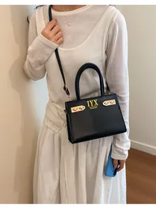 Detail view of stylish black leather women handbag, elegant shoulder tote bag for daily wear.