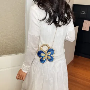 Stylish butterfly shoulder bag with blue glitter wings and gold chain for women daily fashion.