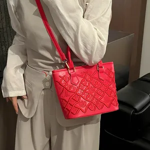 Red embroidered bucket bag for women, stylish tote and chic shoulder crossbody fashion bag.